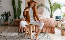 Stylish woman in linen clothes sitting on chair